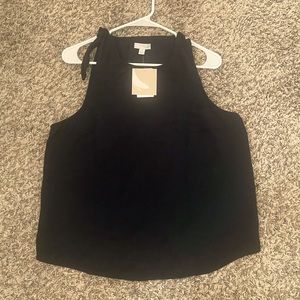 Black sleeveless top.